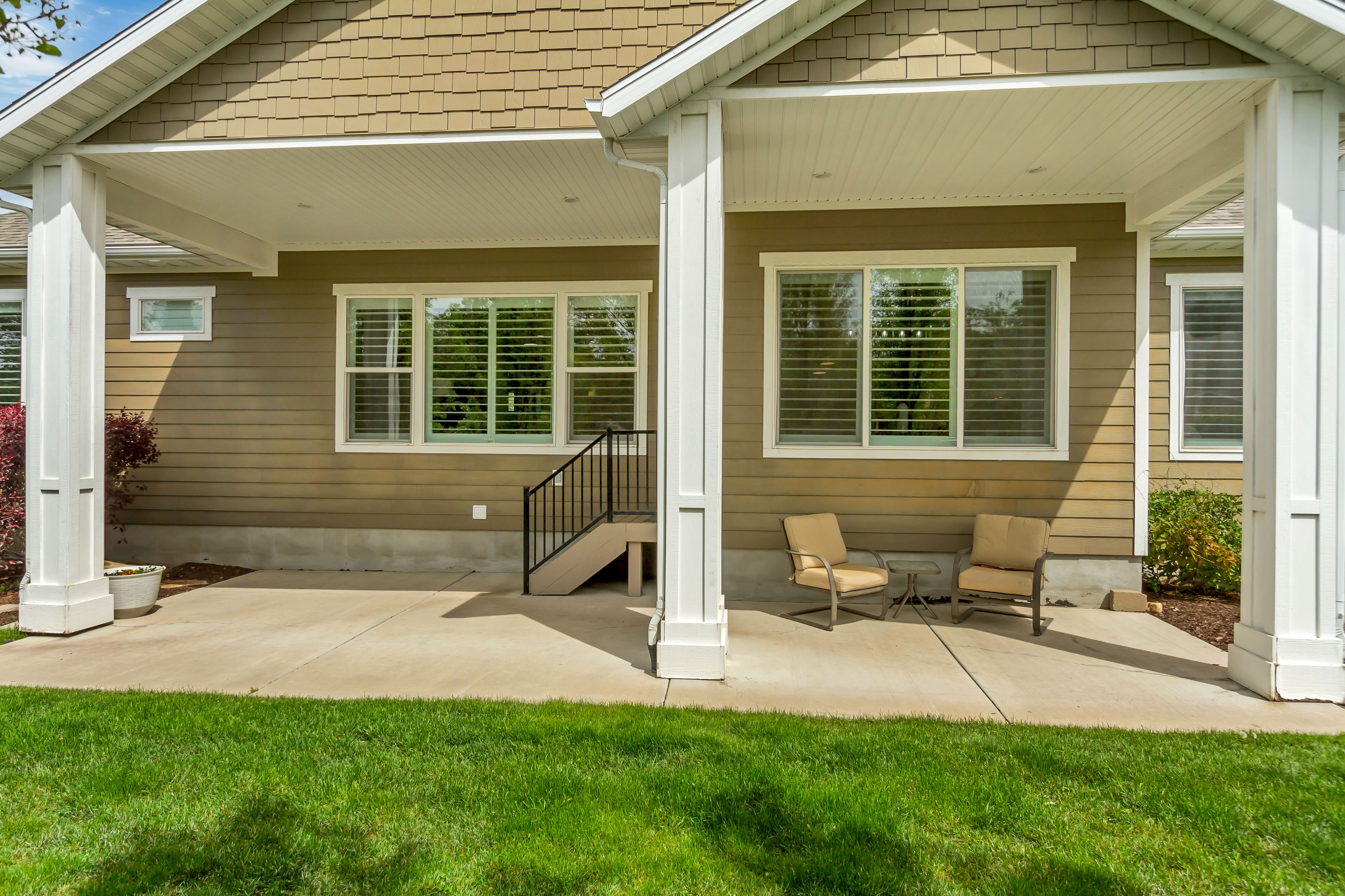 Back of house with a patio area and a yard
