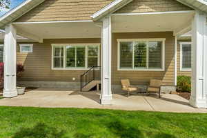 Back of house with a patio area and a yard