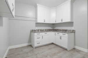 Laundry room featuring baseboards