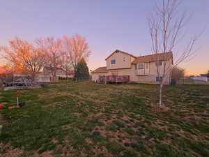 Rear of house w/large deck, lawn area