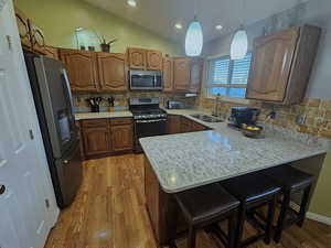 Bar seating, granite counters, tile backsplash, stainless appliances