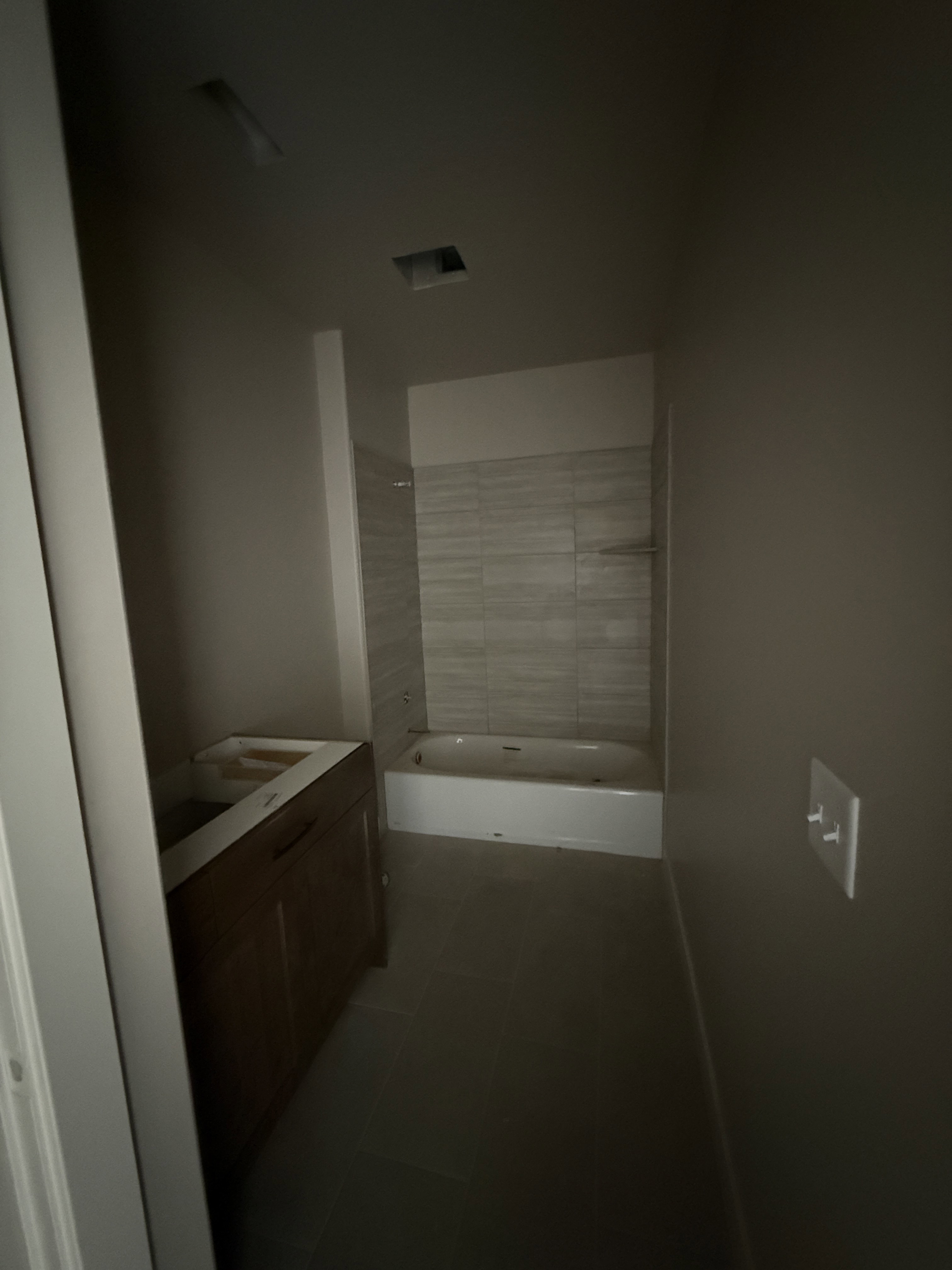 Bathroom with vanity and shower / washtub combination
