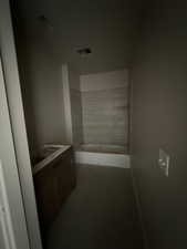 Bathroom with vanity and shower / washtub combination