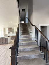 Staircase with a textured ceiling