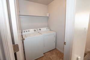 Laundry room with washing machine and dryer and baseboards