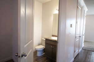 Bathroom featuring vanity and dark wood-style floors