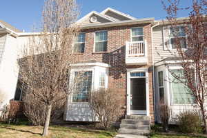 View of front facade featuring entry steps and brick siding