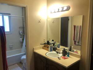 Bathroom with vanity and shower / bath combo