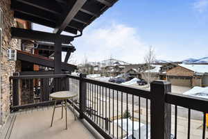 Snow covered back of property featuring a mountain view