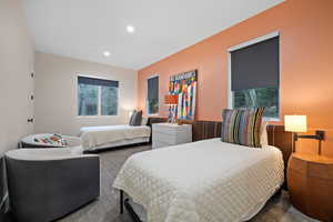 Carpeted bedroom with recessed lighting