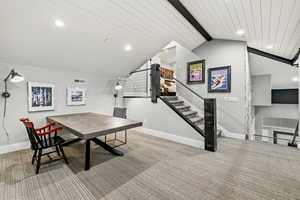 Dining space featuring recessed lighting, light colored carpet, and a wood ceiling with exposed beams