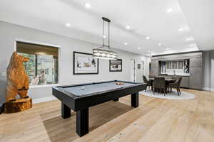Game room with billiards, light wood-style floors, and recessed lighting
