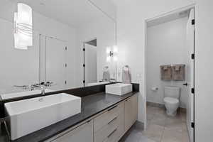 Bathroom featuring double vanity and light tile patterned floors
