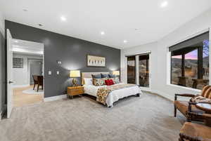 Bedroom featuring light carpet, recessed lighting, and access to outside