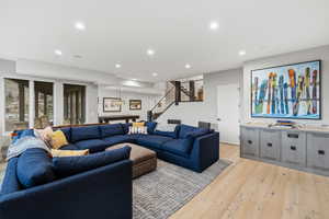 Living room featuring light wood finished floors and recessed lighting
