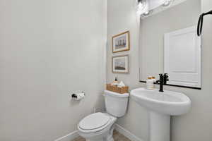 Bathroom with toilet and baseboards