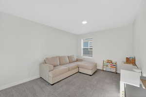 Living area with carpet floors and baseboards