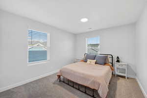 Carpeted bedroom with baseboards