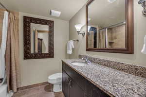 Full bath with vanity, light tile patterned flooring, and shower / bathtub combination with curtain