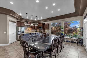 Dining area with recessed lighting and baseboards