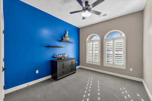 Carpeted bedroom with baseboards and ceiling fan