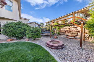 View of yard with a trampoline and a fire pit