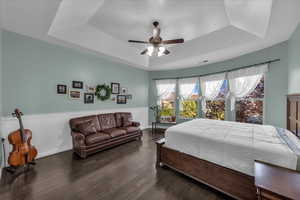 Bedroom with dark wood-style flooring and a ceiling fan