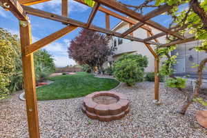 View of yard with a patio area, a pergola, and a fire pit
