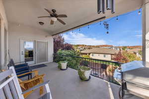 Balcony featuring grilling area, ceiling fan, and a residential view