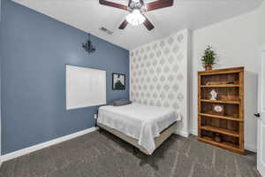 Bedroom featuring dark colored carpet, ceiling fan, and a textured ceiling