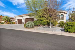 Mediterranean / spanish home featuring stucco siding, driveway, and an attached garage