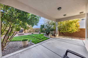 Fenced backyard with an outdoor fire pit and a patio