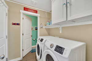 Laundry area with cabinet space and washer and dryer
