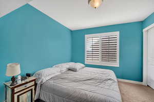 Carpeted bedroom featuring baseboards and a closet