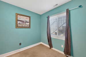 Empty room with baseboards and light carpet