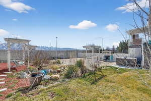 Fenced backyard with a patio area and a mountain view