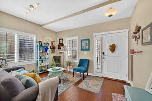 Entrance foyer featuring dark wood-style flooring and baseboards