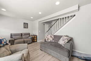 Living room featuring wood finished floors and recessed lighting