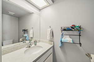 Half bath featuring vanity and toilet