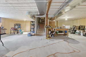 Unfinished basement featuring stairway