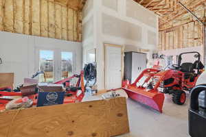 Miscellaneous room with a high ceiling and french doors