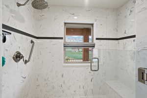 Bathroom with a marble finish shower
