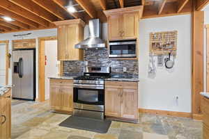Kitchen with stainless steel appliances, dark stone counters, and tasteful backsplash