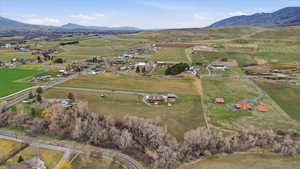 View of property location with rural landscape, a mountainous background, and large plots for crops