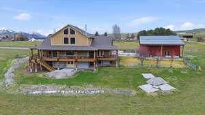 Rear view of property featuring a mountain view and an outbuilding