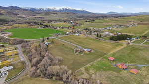 Aerial overview of property's location featuring rural landscape and a mountainous background