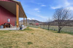View of yard featuring a mountain view and a patio area