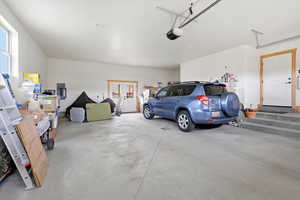 Garage with electric panel and a garage door opener