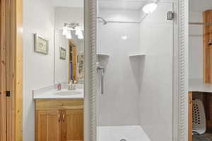 Bathroom with vanity and a stall shower