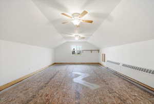 Additional living space featuring a ceiling fan and baseboards